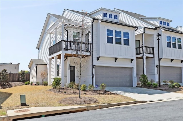 1433 Halpern Ln, Kennesaw, GA 30144 - view of front facade featuring board and batten siding, concrete driveway, a pergola, and a garage