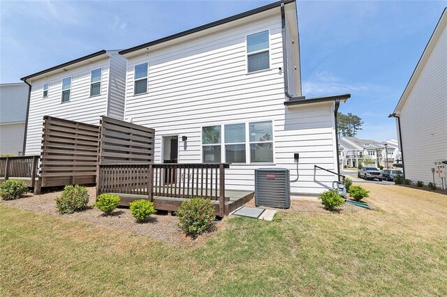 1433 Halpern Ln, Kennesaw, GA 30144 - back of house with a lawn, a wooden deck, and central AC