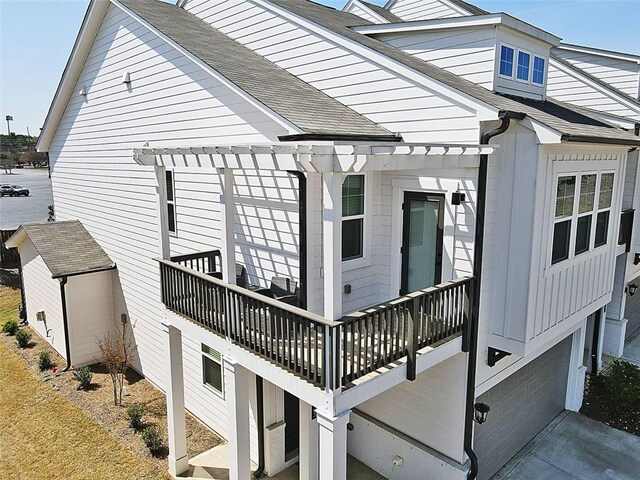 1433 Halpern Ln, Kennesaw, GA 30144 - view of property exterior featuring a garage, a pergola, and roof with shingles
