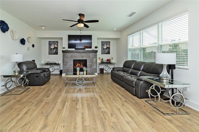 1433 Halpern Ln, Kennesaw, GA 30144 - living room with a ceiling fan, visible vents, a tile fireplace, and wood finished floors