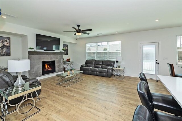 1433 Halpern Ln, Kennesaw, GA 30144 - living area featuring visible vents, wood finished floors, a tile fireplace, and a ceiling fan