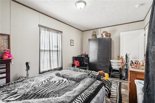 bedroom featuring ornamental molding and hardwood / wood-style floors