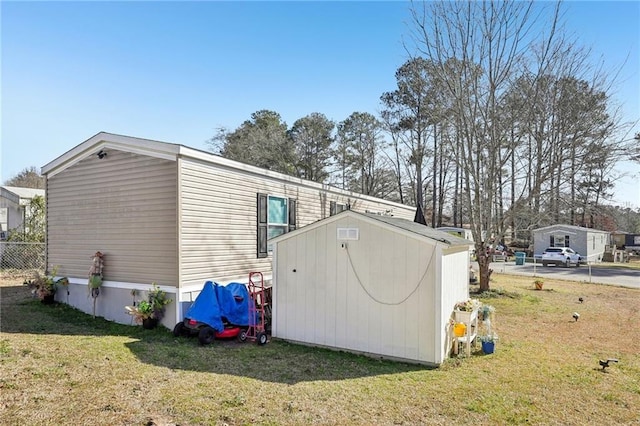 view of outbuilding featuring a lawn