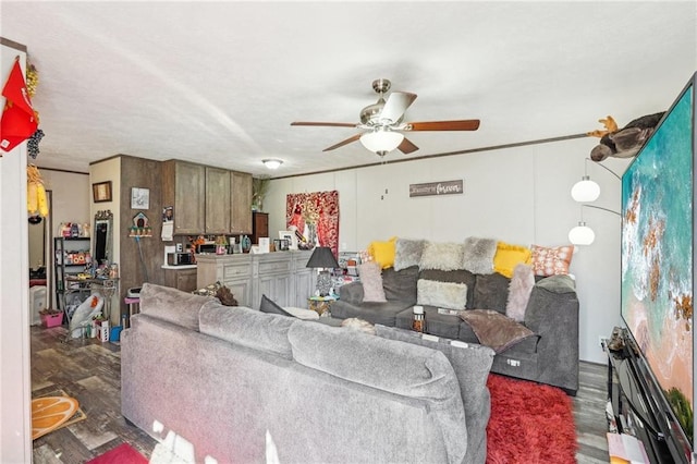 living room featuring dark wood-type flooring and ceiling fan