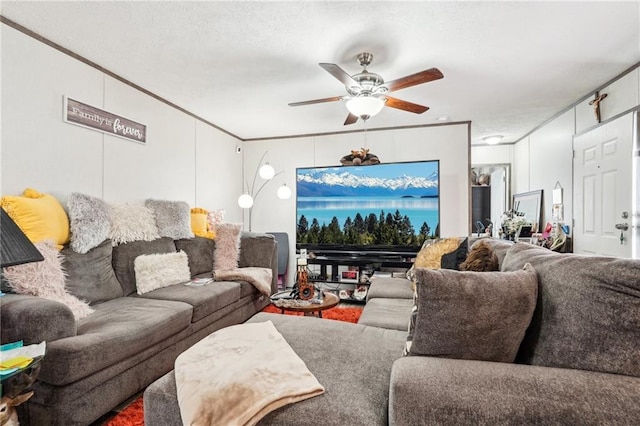 living room featuring crown molding and ceiling fan