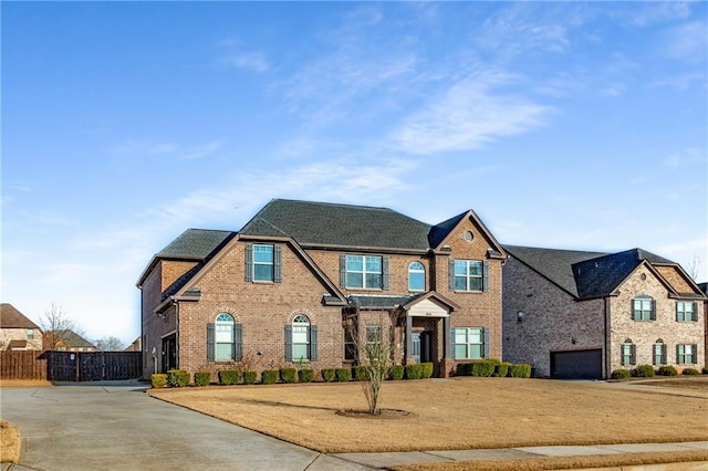 view of front of house with fence and brick siding