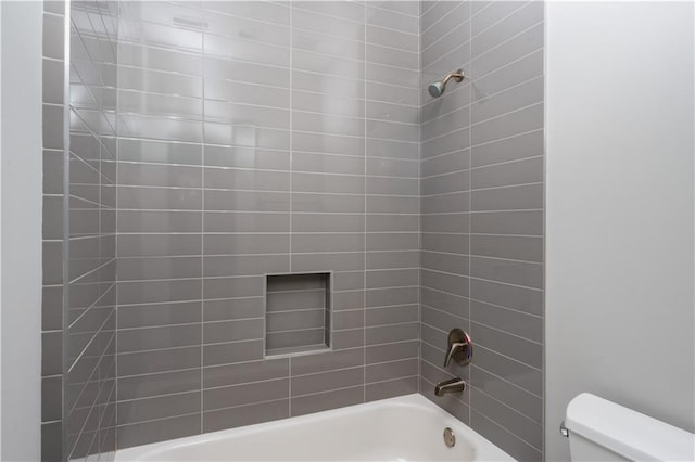 bathroom with toilet and washtub / shower combination