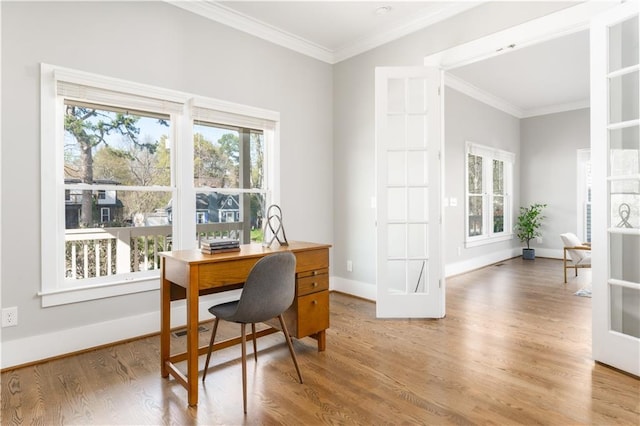 dining room with crown molding, baseboards, and wood finished floors