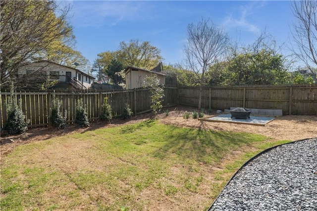 view of yard featuring an outdoor fire pit and a fenced backyard