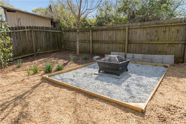 view of yard featuring an outdoor fire pit and a fenced backyard