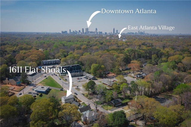 bird's eye view featuring a forest view and a view of city