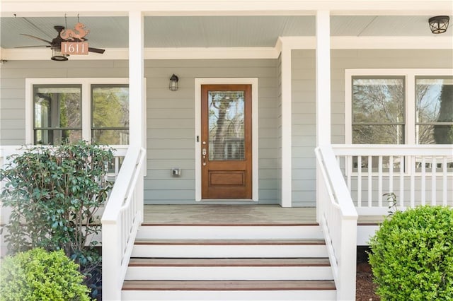 view of exterior entry featuring covered porch and ceiling fan