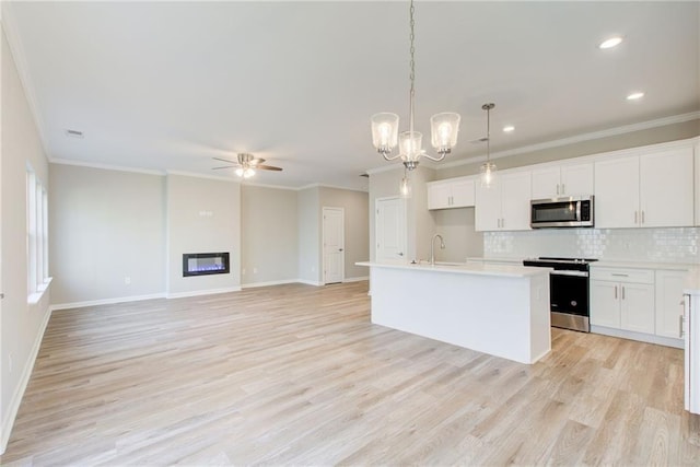 93 Portico Pl, Newnan, GA 30265 - kitchen featuring appliances with stainless steel finishes, light wood finished floors, a ceiling fan, decorative backsplash, and ornamental molding