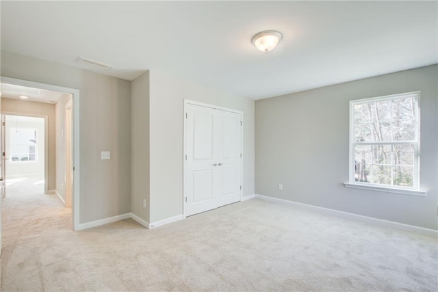 93 Portico Pl, Newnan, GA 30265 - unfurnished bedroom featuring attic access, light colored carpet, and a closet