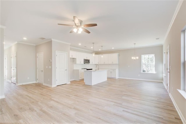 93 Portico Pl, Newnan, GA 30265 - unfurnished living room with a ceiling fan, ornamental molding, recessed lighting, light wood-style floors, and a chandelier