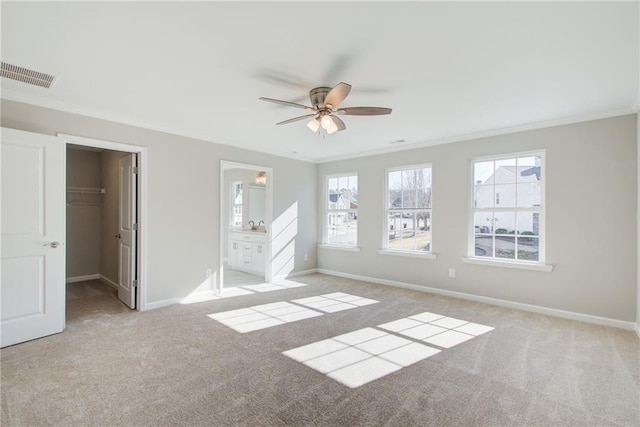 93 Portico Pl, Newnan, GA 30265 - unfurnished bedroom with ornamental molding, carpet floors, a walk in closet, connected bathroom, and a closet