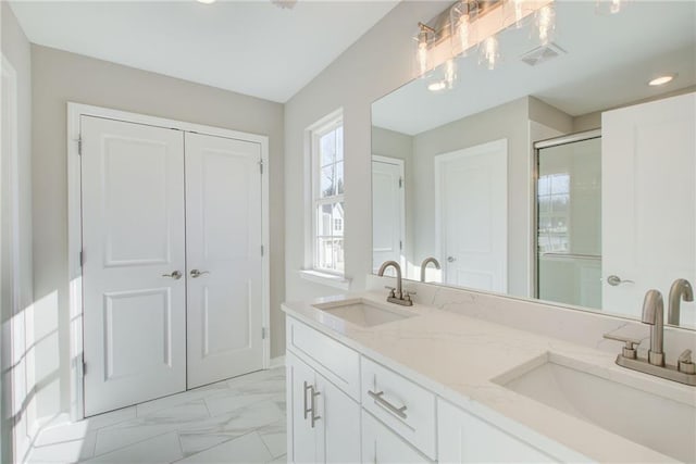 93 Portico Pl, Newnan, GA 30265 - bathroom with double vanity, a shower with shower door, marble look tile flooring, and recessed lighting