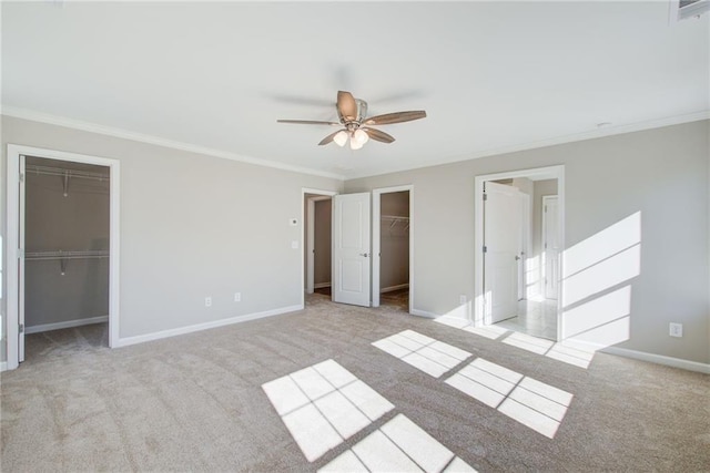 93 Portico Pl, Newnan, GA 30265 - unfurnished bedroom with a spacious closet, ornamental molding, a closet, carpet, and a ceiling fan