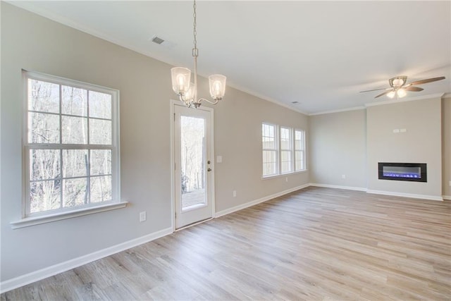 93 Portico Pl, Newnan, GA 30265 - unfurnished living room with light wood-type flooring, a chandelier, crown molding, a glass covered fireplace, and ceiling fan