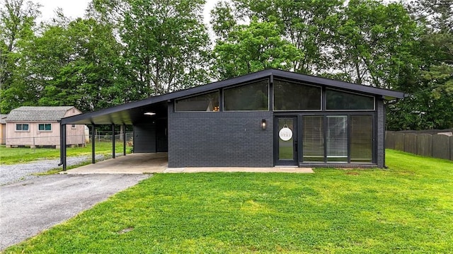 215 Maplewood Dr SW, Calhoun, GA 30701 - mid-century modern home featuring asphalt driveway, brick siding, and an attached carport