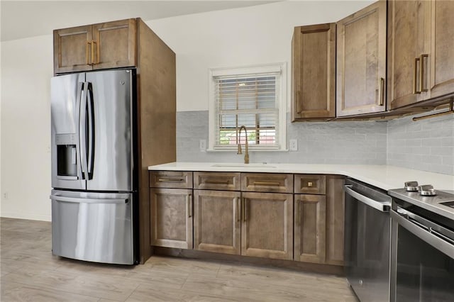 215 Maplewood Dr SW, Calhoun, GA 30701 - kitchen with stainless steel appliances, a sink, decorative backsplash, and light countertops