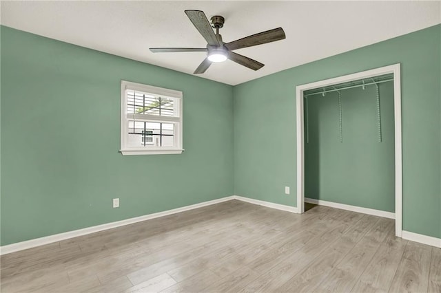 215 Maplewood Dr SW, Calhoun, GA 30701 - unfurnished bedroom with wood finished floors, baseboards, a closet, and a ceiling fan