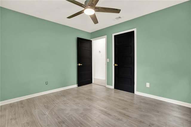 215 Maplewood Dr SW, Calhoun, GA 30701 - empty room featuring a ceiling fan, baseboards, and light wood-style flooring