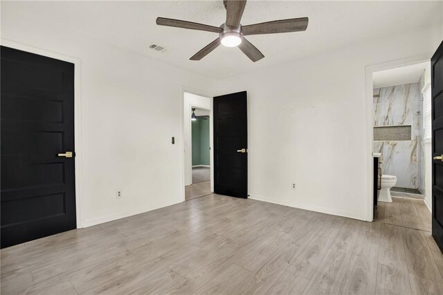 215 Maplewood Dr SW, Calhoun, GA 30701 - unfurnished bedroom with light wood-type flooring, baseboards, connected bathroom, and ceiling fan