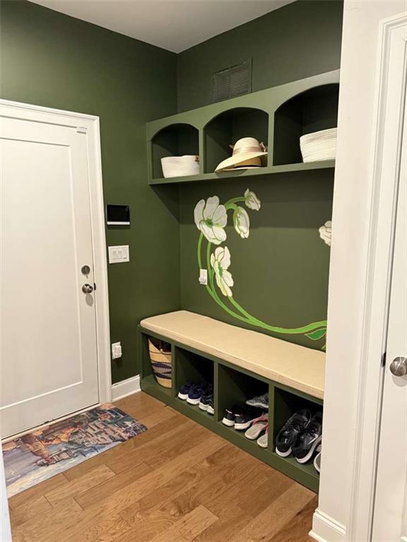 mudroom featuring wood finished floors and baseboards