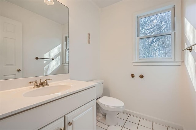 bathroom featuring vanity, toilet, and tile patterned flooring