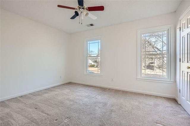 carpeted spare room with ceiling fan