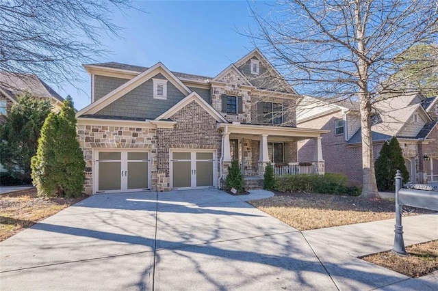 craftsman-style house with a garage, french doors, and covered porch