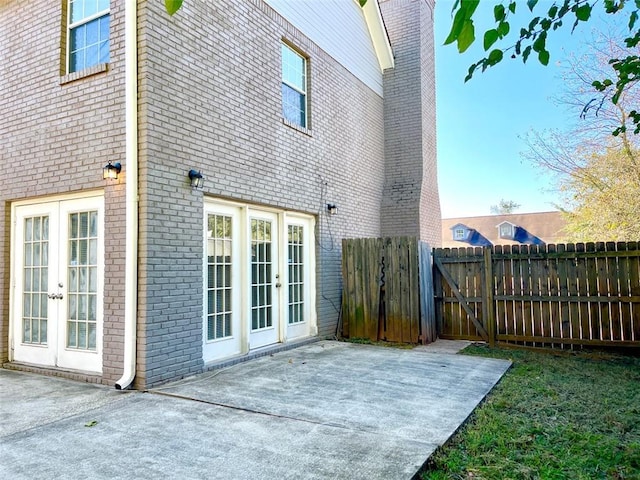 2124 Hickory Bnd SE, Conyers, GA 30013 - rear view of house with french doors, a patio area, and brick siding