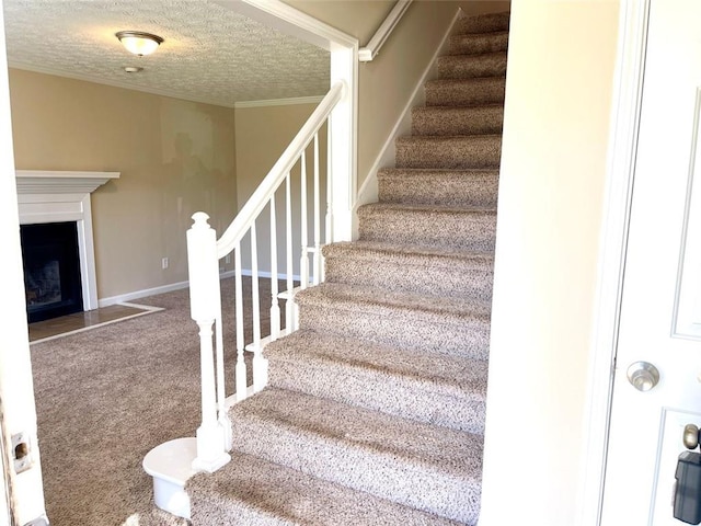 2124 Hickory Bnd SE, Conyers, GA 30013 - stairway with a textured ceiling, carpet floors, ornamental molding, and a fireplace with flush hearth