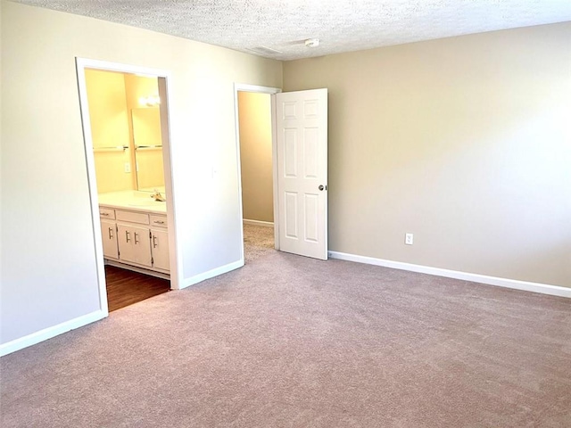 2124 Hickory Bnd SE, Conyers, GA 30013 - unfurnished bedroom featuring dark colored carpet, a textured ceiling, and connected bathroom