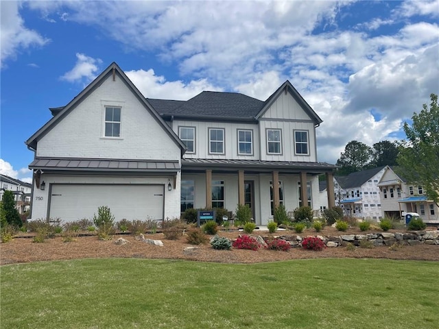 750 Keystone Dr, Woodstock, GA 30188 - view of front of property with a porch, a front yard, a standing seam roof, an attached garage, and board and batten siding