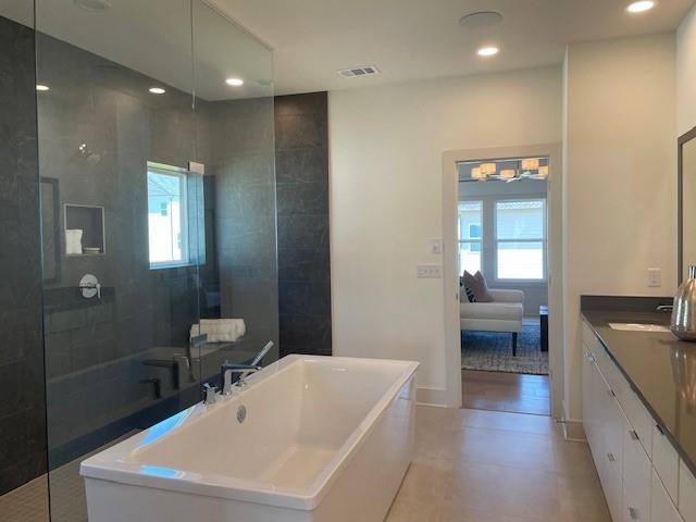 750 Keystone Dr, Woodstock, GA 30188 - bathroom featuring healthy amount of natural light, a freestanding tub, walk in shower, vanity, and recessed lighting