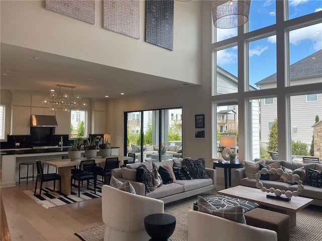 750 Keystone Dr, Woodstock, GA 30188 - living room with light wood-type flooring, a chandelier, and a high ceiling