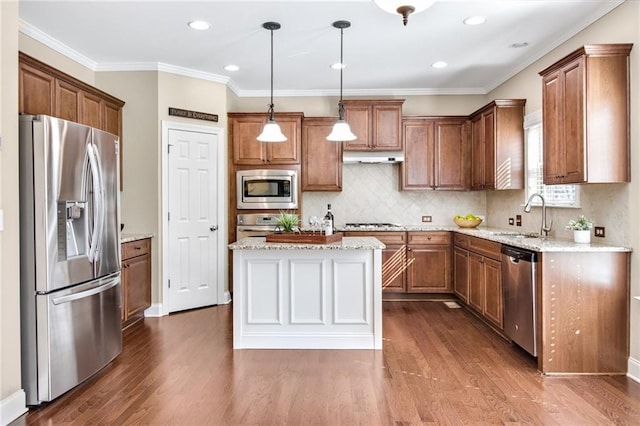 kitchen with dark wood-style floors, appliances with stainless steel finishes, a sink, and brown cabinets