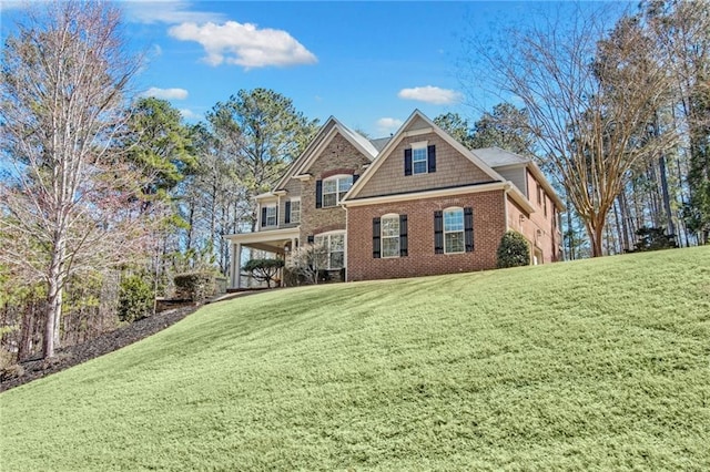 view of front facade with a front lawn and brick siding