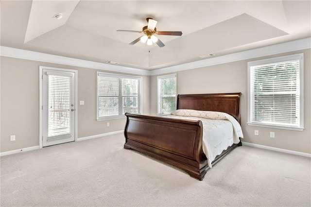 carpeted bedroom with access to exterior, a tray ceiling, visible vents, and baseboards