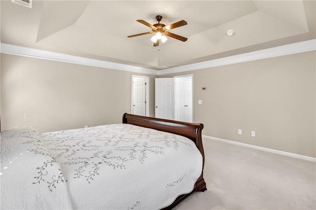 bedroom featuring ornamental molding, carpet, a raised ceiling, and baseboards