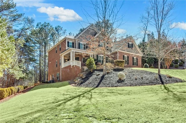 exterior space featuring brick siding and a lawn