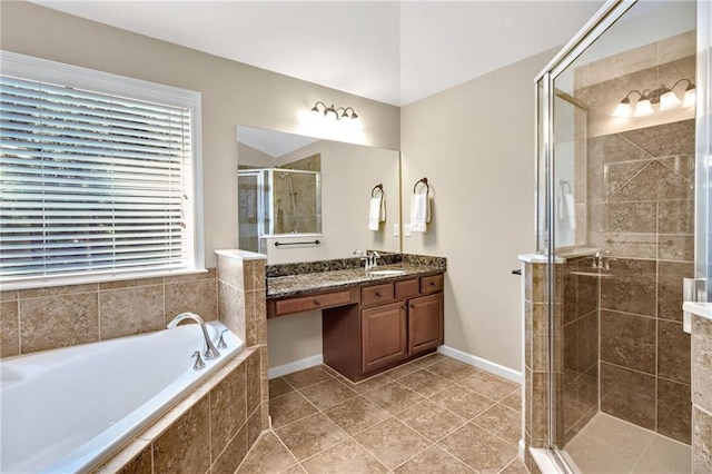 full bath featuring a stall shower, baseboards, tile patterned flooring, vanity, and a bath