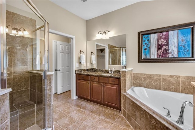 bathroom with double vanity, a stall shower, a bath, and tile patterned floors