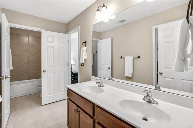 full bath featuring double vanity, tile patterned flooring, visible vents, and a sink