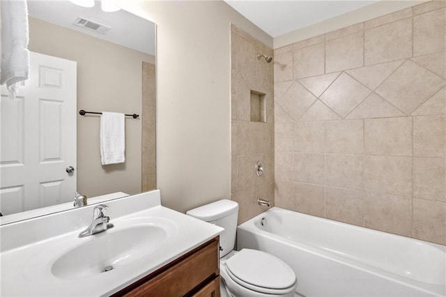 bathroom with toilet, shower / tub combination, visible vents, and vanity