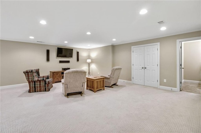 sitting room with baseboards, light colored carpet, visible vents, and recessed lighting