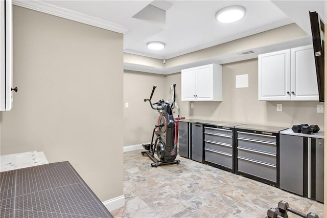 exercise room with visible vents, baseboards, and crown molding