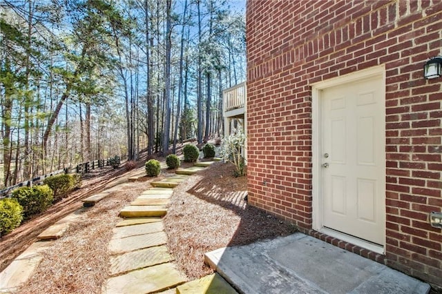 doorway to property with brick siding